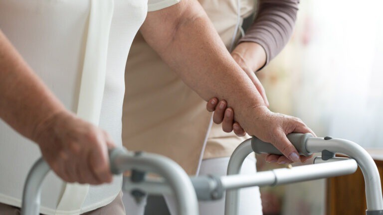 patient walking with wheel zimmer